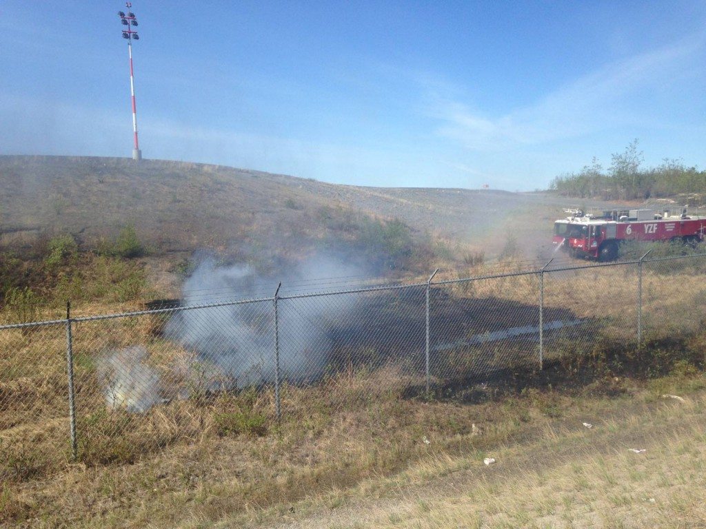 Airport fire crew tackles brush fire