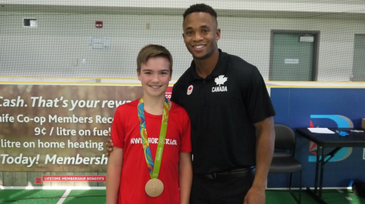 A fan takes a photo with Haynes while sporting his bronze medal.