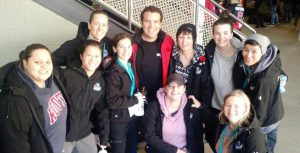 Members of the NWT Rebels pose with television personality Rick Mercer.